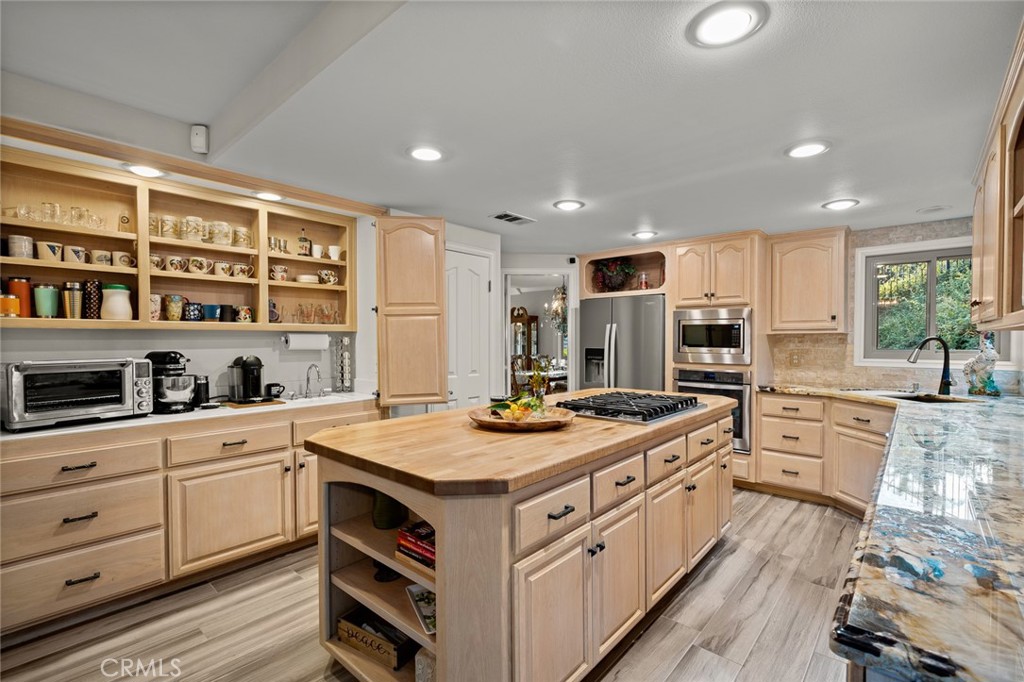 1624 Alessandro Road Redlands, CA 92373 - Photo 13 of 58 a kitchen with a stove top oven sink and cabinets
