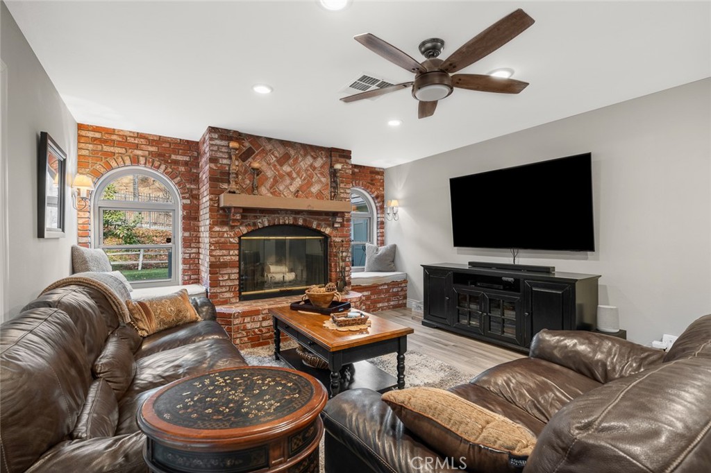 1624 Alessandro Road Redlands, CA 92373 - Photo 17 of 58 a living room with furniture a flat screen tv and a fireplace