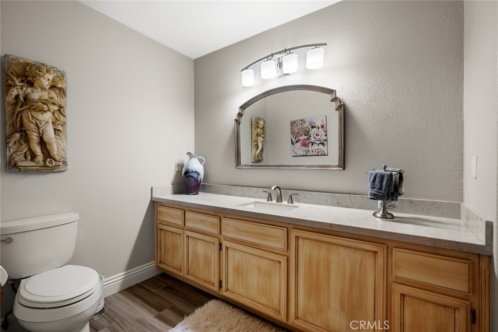 1624 Alessandro Road Redlands, CA 92373 - Photo 19 of 58 a bathroom with a toilet a sink and mirror