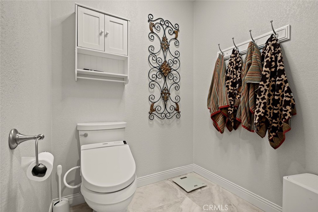 1624 Alessandro Road Redlands, CA 92373 - Photo 30 of 58 a bathroom with a toilet and a shower curtain