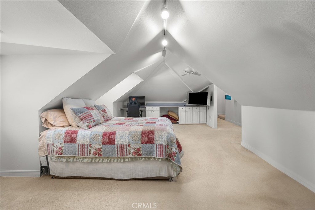 1624 Alessandro Road Redlands, CA 92373 - Photo 39 of 58 a spacious bedroom with a bed and a flat screen tv