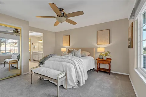 a spacious bedroom with a bed and a chandelier