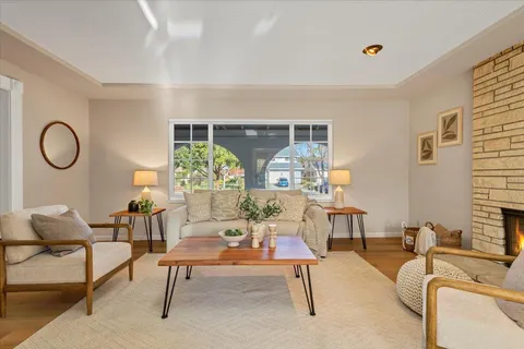 a living room with furniture rug and window