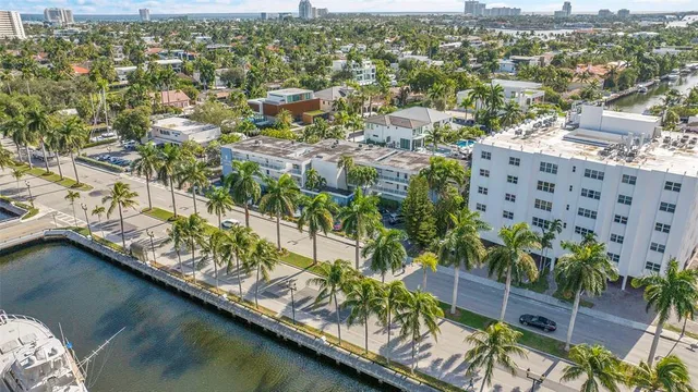 an aerial view of residential houses with outdoor space and swimming pool
