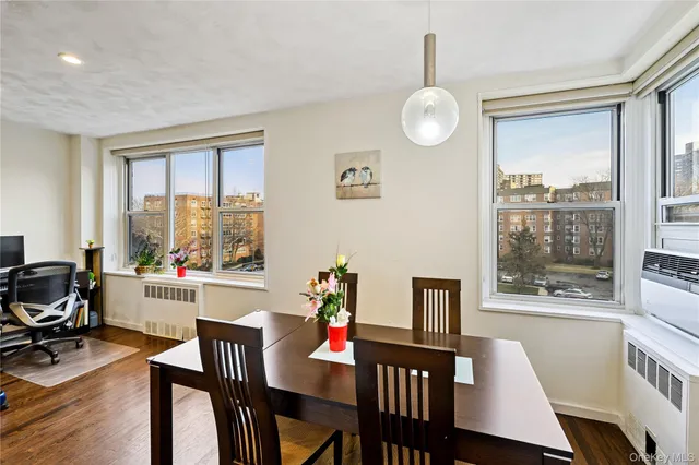 a view of a dining room with furniture window and wooden floor