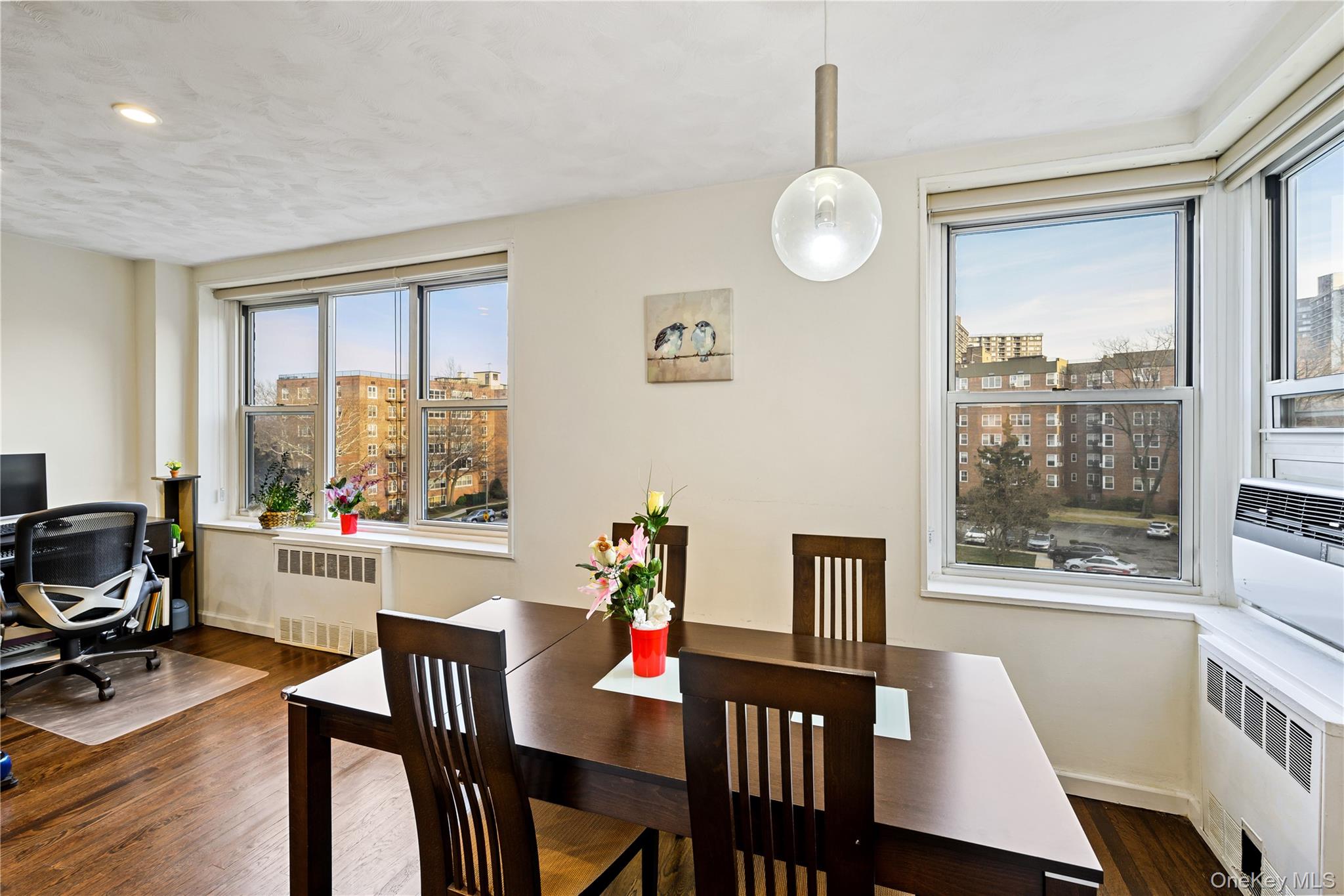 18-40 211th Street, Unit 4E Queens, NY 11360 - Photo 6 of 12 a view of a dining room with furniture window and wooden floor