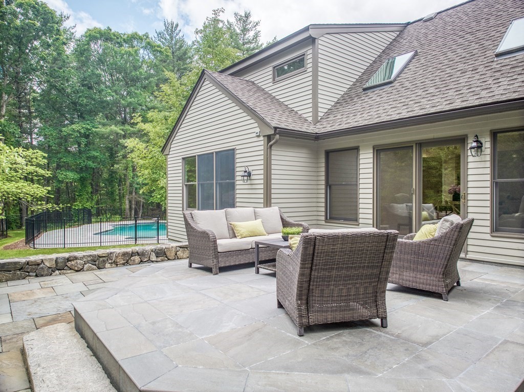 246 Elizabeth Ridge Road Carlisle, MA 01741 - Photo 24 of 38 a view of a patio with couches chairs and wooden floor