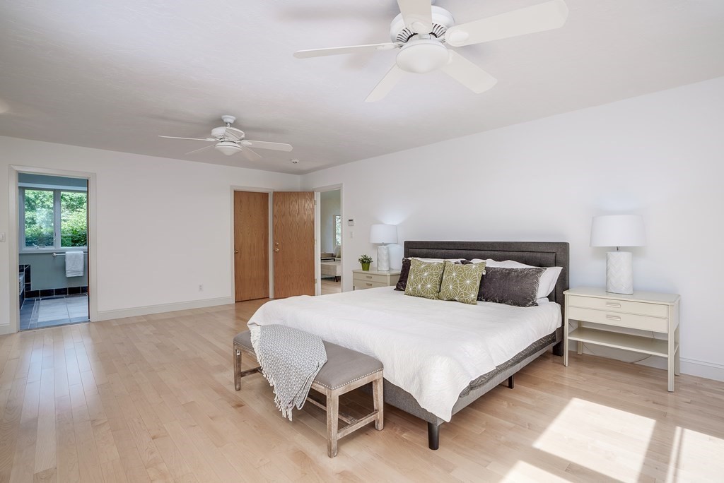 246 Elizabeth Ridge Road Carlisle, MA 01741 - Photo 25 of 38 a bedroom with a bed and a chandelier