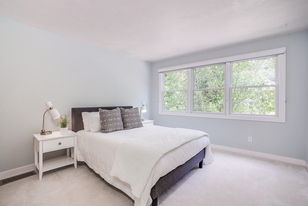 246 Elizabeth Ridge Road Carlisle, MA 01741 - Photo 30 of 38 a large bed sitting in a bedroom next to a window