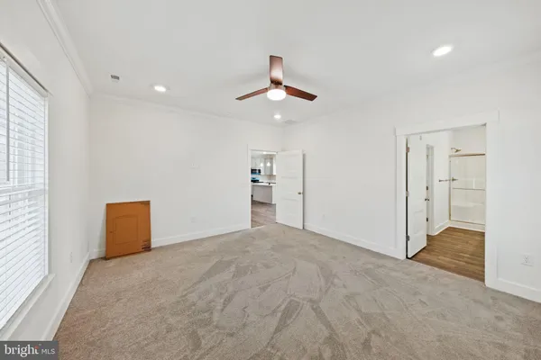 an empty room with closet and windows