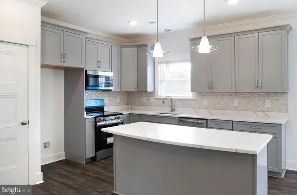 a view of an empty room with a window and closet