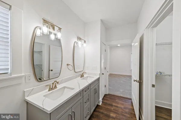 a bathroom with 2 sink and a mirror