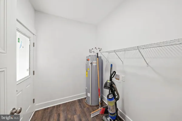 a bathroom with a sink a toilet a mirror and shower