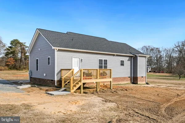 a view of a house with wooden fence