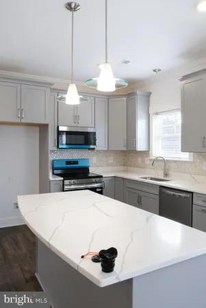 a kitchen with a sink a stove and cabinets