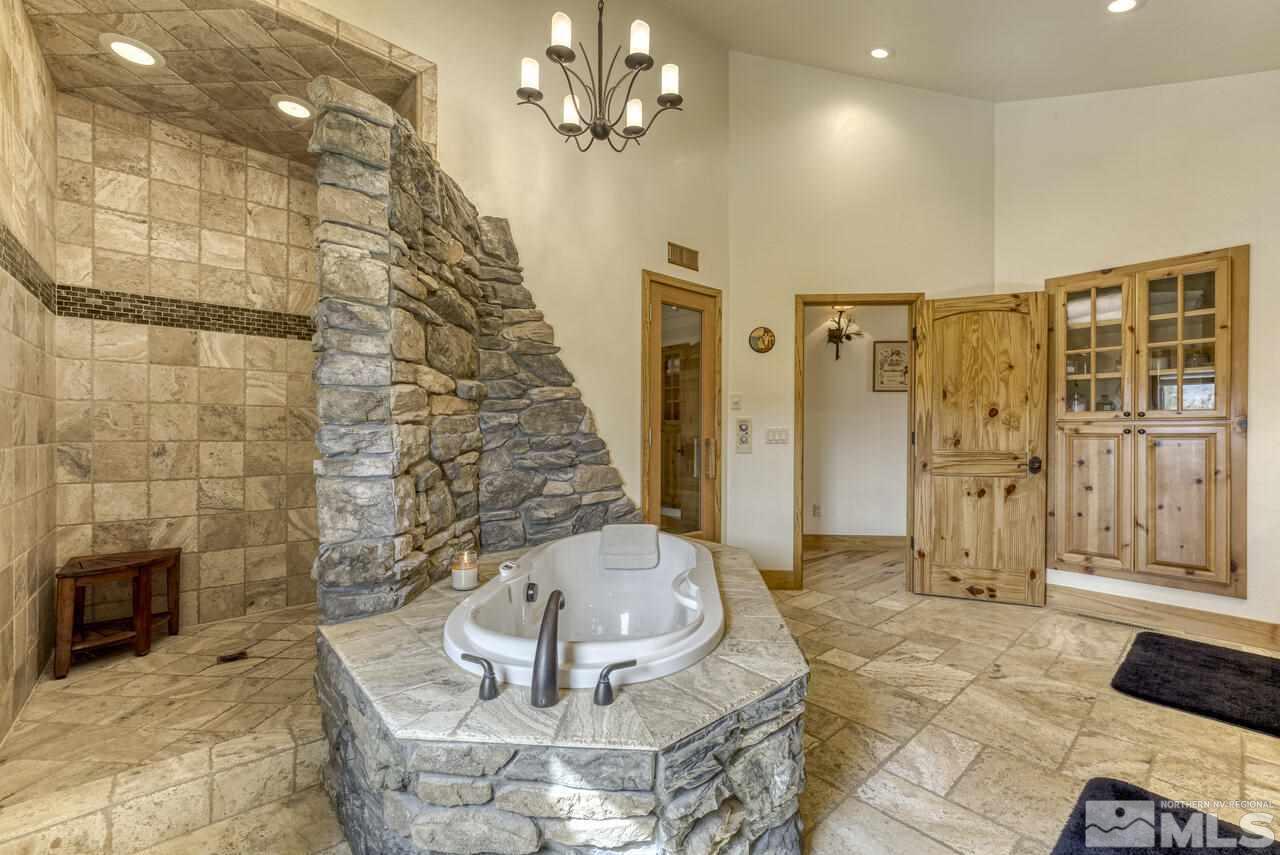 40 Grannie Lane Wellington, NV 89444 - Photo 17 of 40 a bathroom with a glass shower door a sink and a shower