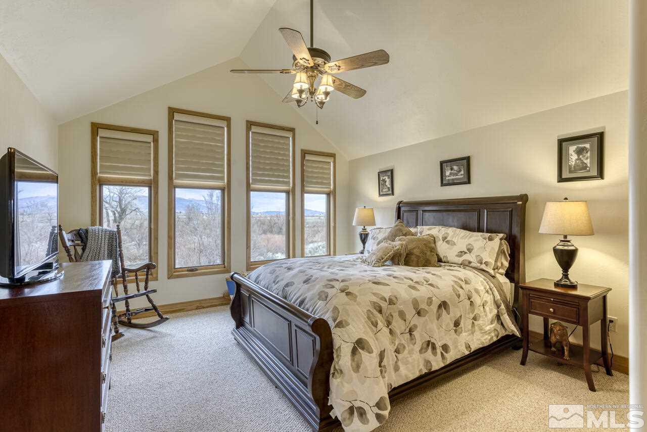 40 Grannie Lane Wellington, NV 89444 - Photo 19 of 40 a bedroom with a bed and a chandelier