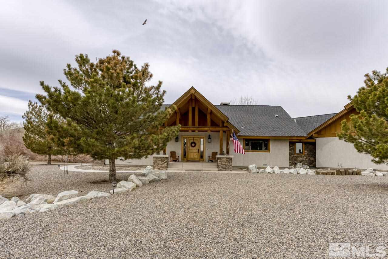 40 Grannie Lane Wellington, NV 89444 - Photo 2 of 40 a front view of a house with a yard and garage