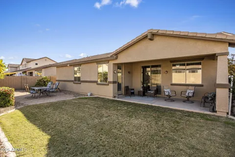 a view of a house with backyard and sitting area