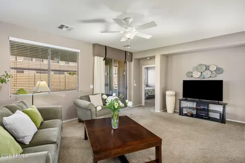 a living room with furniture a flat screen tv and a large window