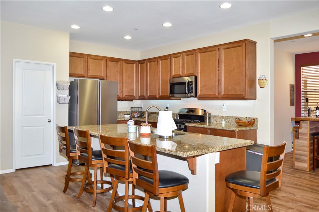 166 Fox Lane Calimesa, CA 92320 - Photo 21 of 76 This Kitchen is a Great Place to Gather with Granite-topped Counters, Island Seating, Stainless Steel Appliances, a Coffee Bar, and a Walk-in Pantry - All Open to the Living Area, Dining Room, and Back Patio