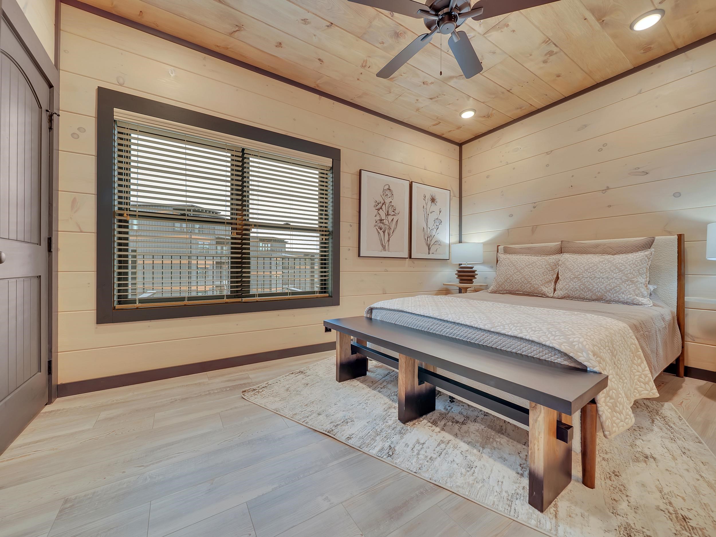 1319 Wildhorse Ridge Way, Unit LOT 143R Sevierville, TN 37862 - Photo 11 of 39 a bedroom with a bed and a chandelier