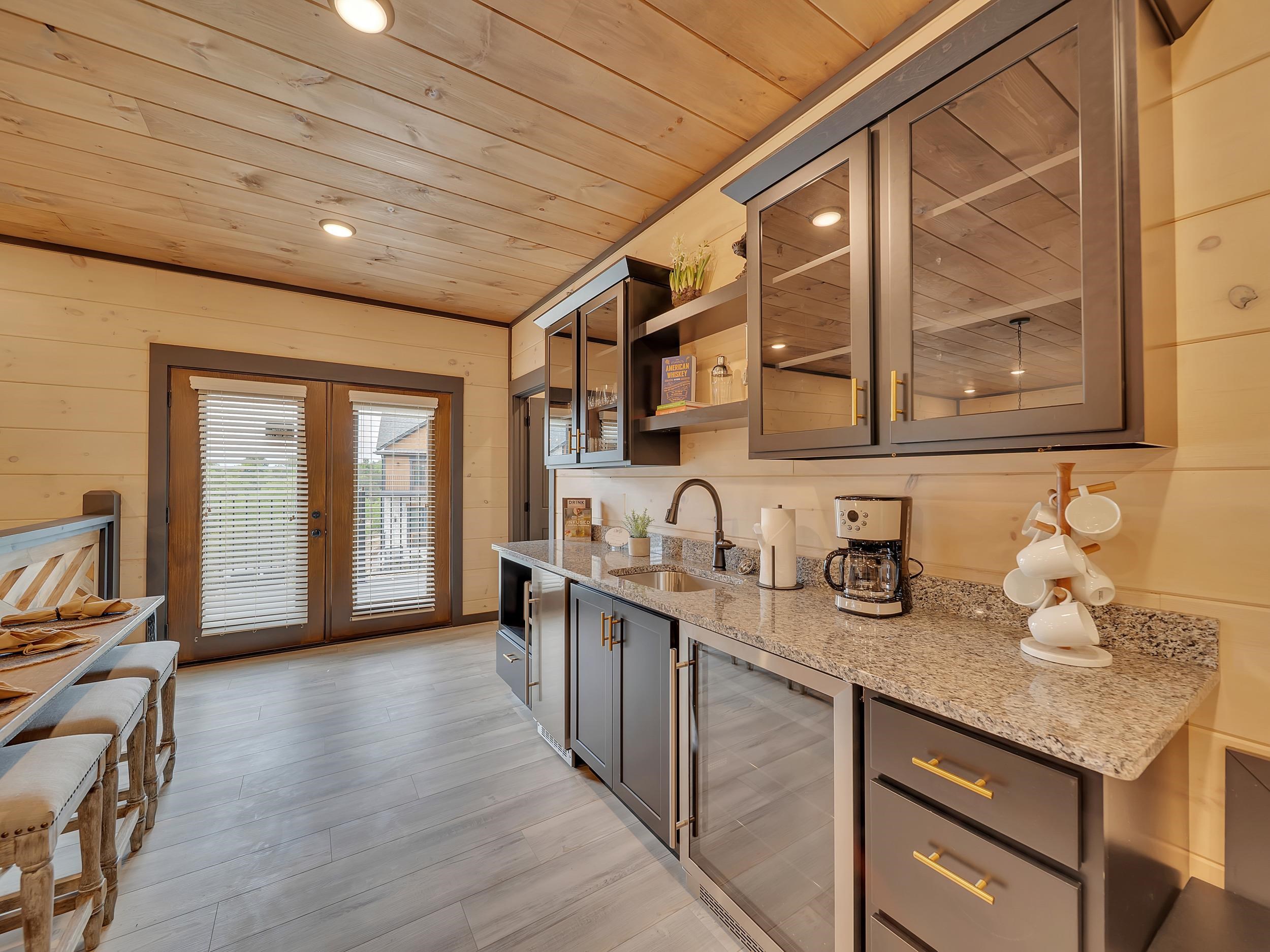 1319 Wildhorse Ridge Way, Unit LOT 143R Sevierville, TN 37862 - Photo 16 of 39 a kitchen with sink cabinets and chandelier