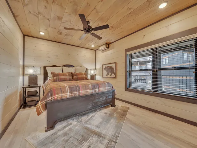 a bedroom with a large bed and a chandelier