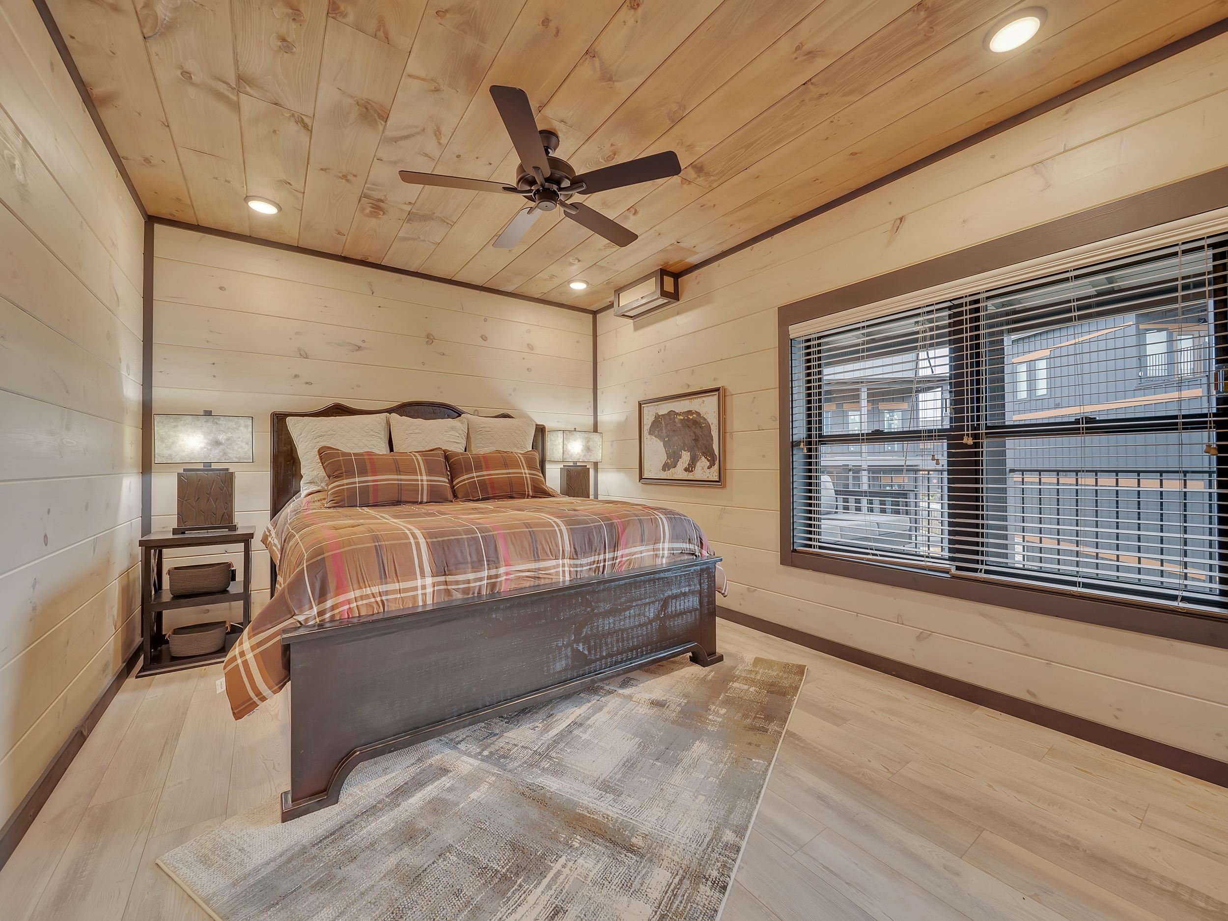 1319 Wildhorse Ridge Way, Unit LOT 143R Sevierville, TN 37862 - Photo 17 of 39 a bedroom with a large bed and a chandelier fan