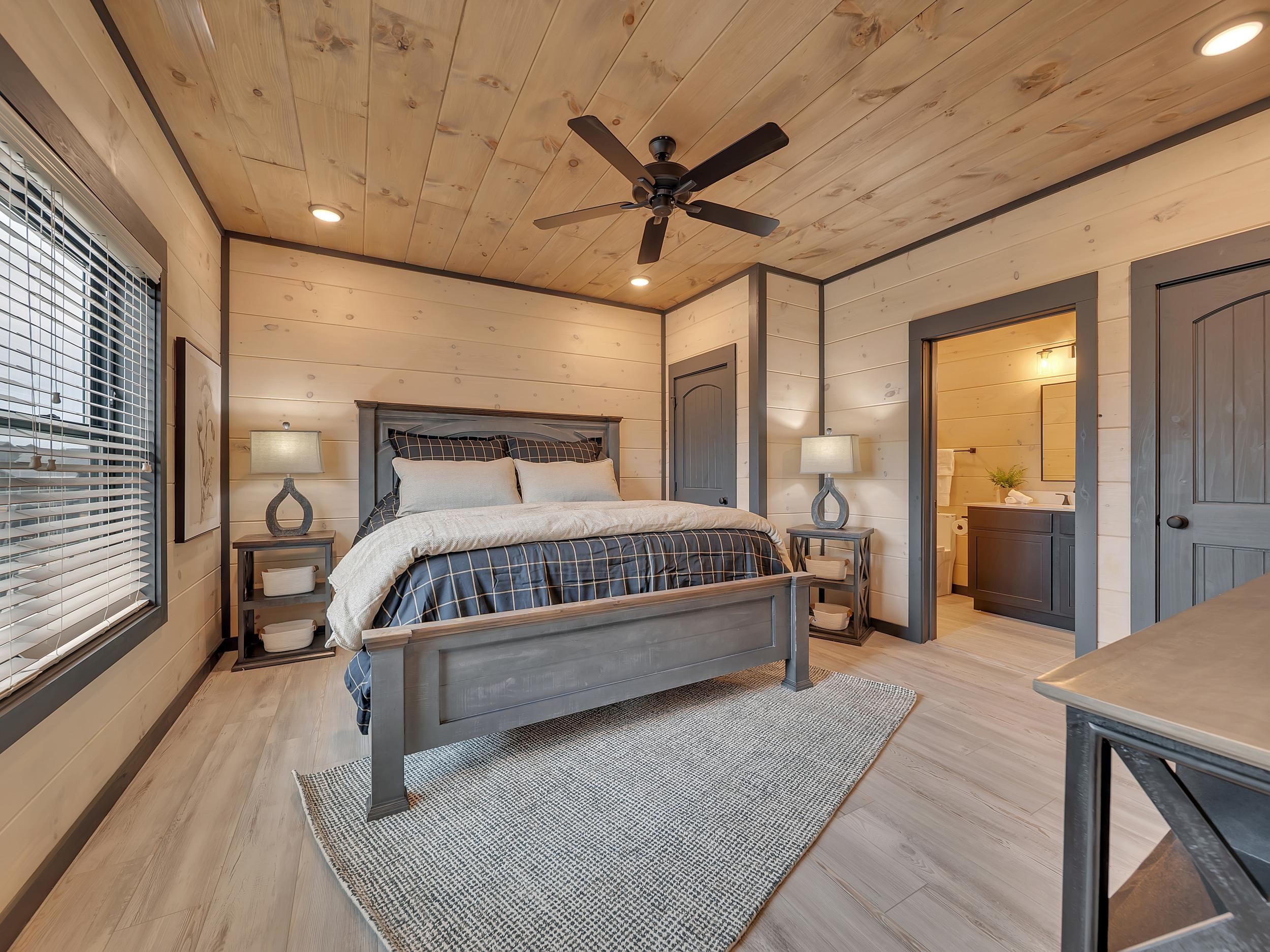 1319 Wildhorse Ridge Way, Unit LOT 143R Sevierville, TN 37862 - Photo 18 of 39 a bedroom with a large bed and a chandelier