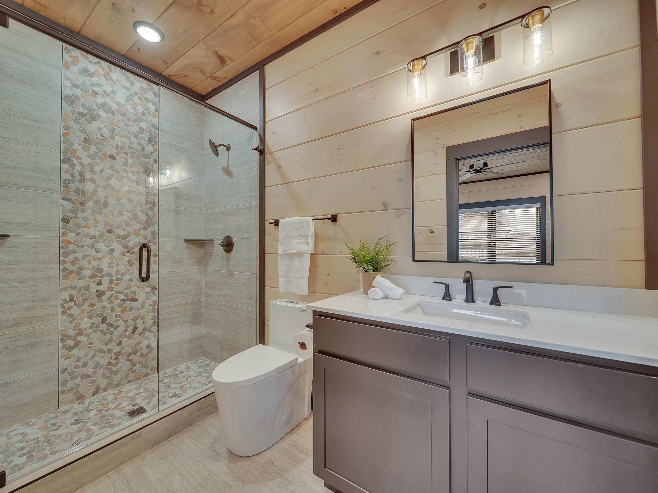 1319 Wildhorse Ridge Way, Unit LOT 143R Sevierville, TN 37862 - Photo 19 of 39 a bathroom with a double vanity sink toilet and shower