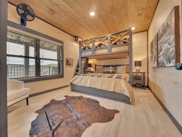 a spacious bedroom with a bed and a chandelier