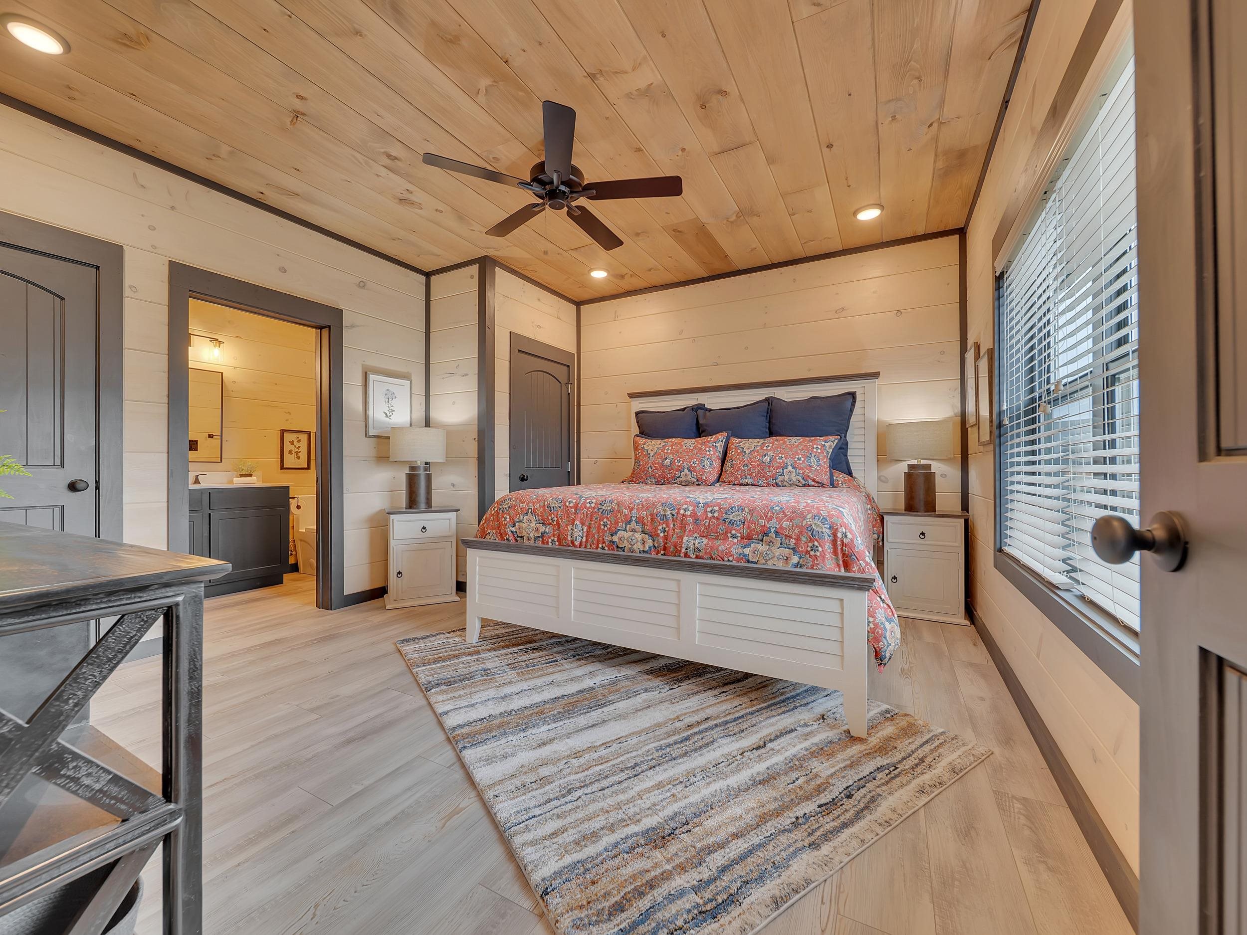 1319 Wildhorse Ridge Way, Unit LOT 143R Sevierville, TN 37862 - Photo 21 of 39 a spacious bedroom with a bed and a chandelier