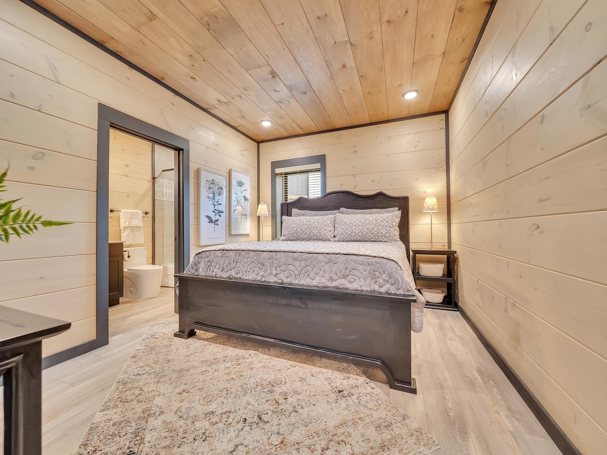 1319 Wildhorse Ridge Way, Unit LOT 143R Sevierville, TN 37862 - Photo 24 of 39 a spacious bedroom with a large bed and a window