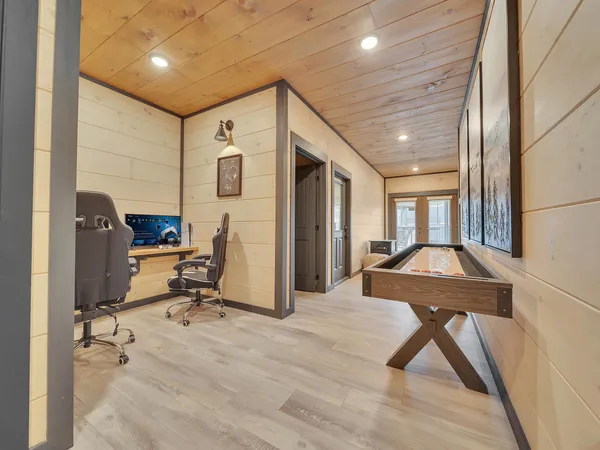 a view of a room with a large window and wooden floor