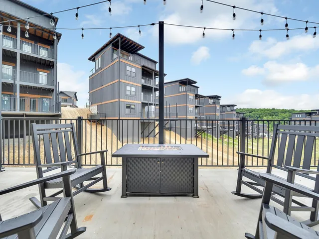 a roof deck with a couch and a potted plant on it