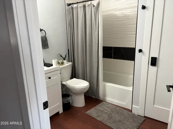 a white toilet sitting next to a bathroom sink