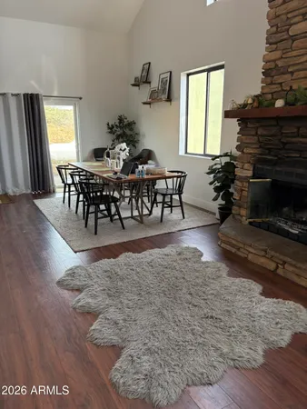 a living room with furniture a dining table and a fireplace