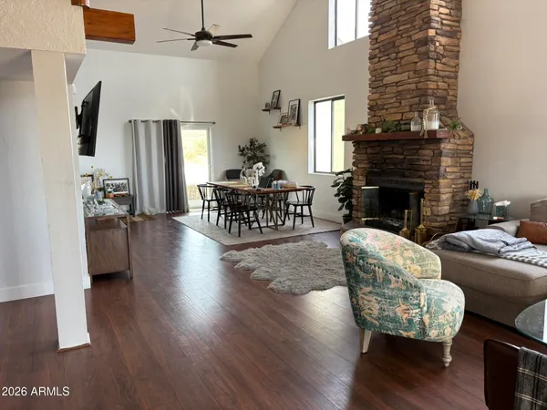 a living room with furniture wooden floor and a fireplace
