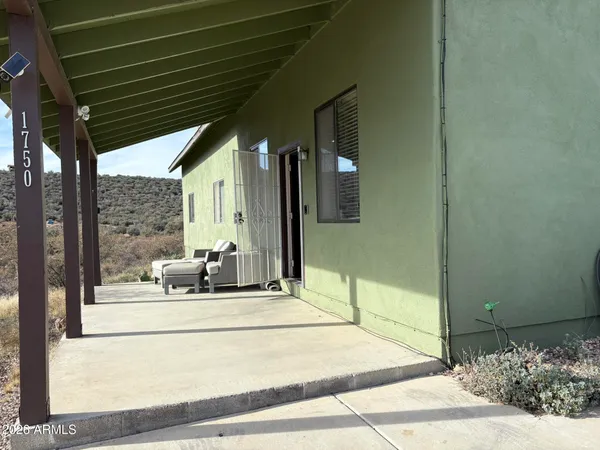 a bedroom with furniture and large windows