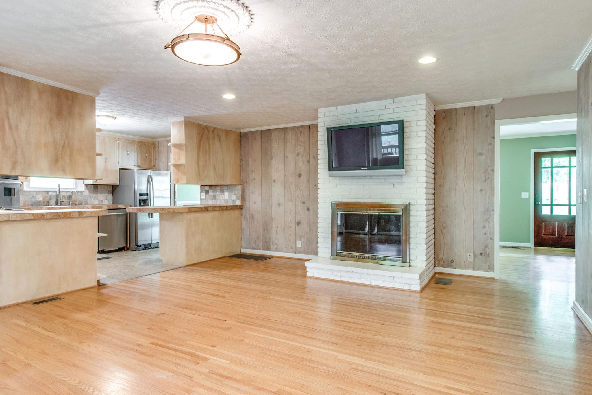 711 Starlit Road Nashville, TN 37205 - Photo 7 of 21 Kitchen opens to large informal family area with wood burning fireplace