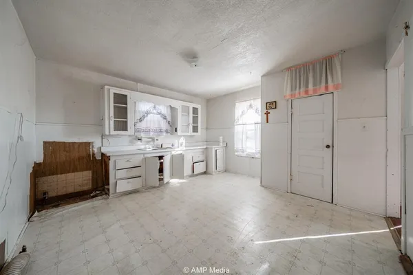 a room with a couch and a refrigerator