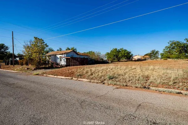 a view of a road with a building in the background