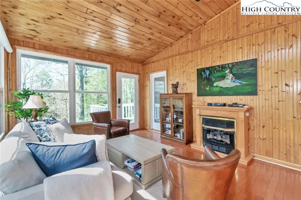 a living room with fireplace furniture and a flat screen tv