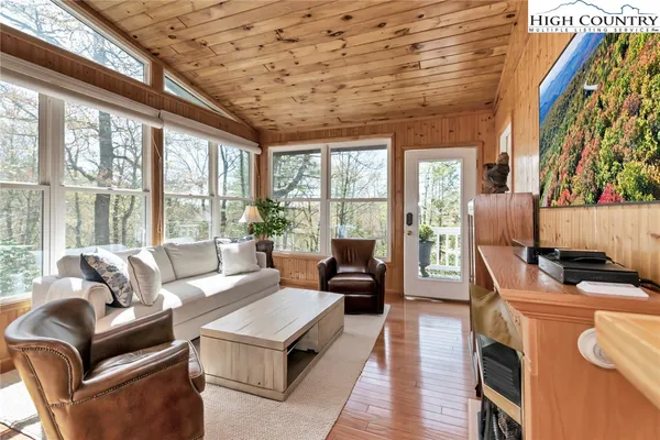 a living room with furniture and a floor to ceiling window