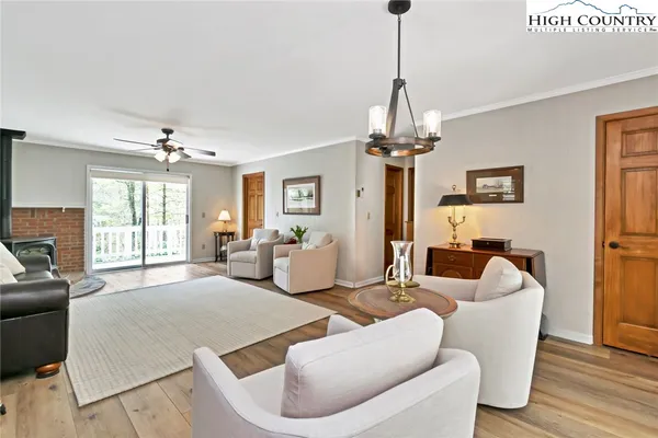 a living room with furniture a chandelier and a window