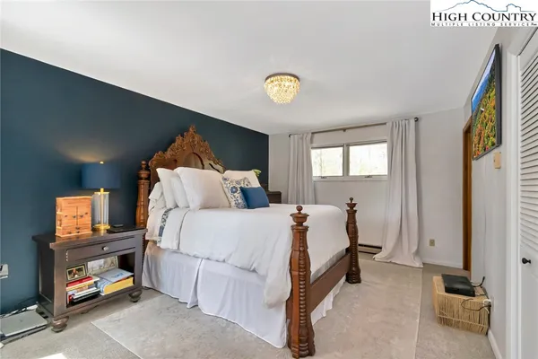 a bed room with a bed and a tv