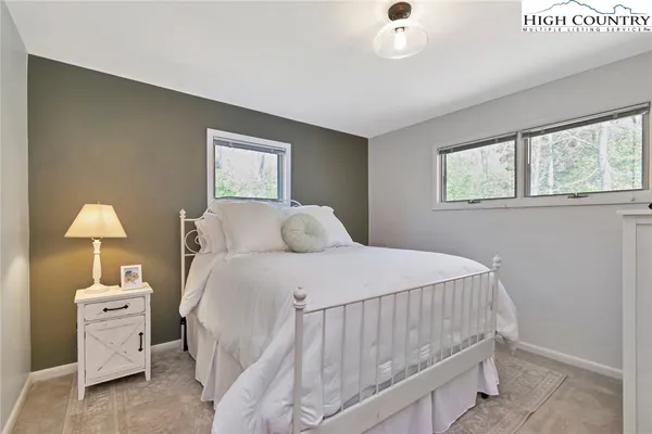 a bedroom with a bed and a night stand