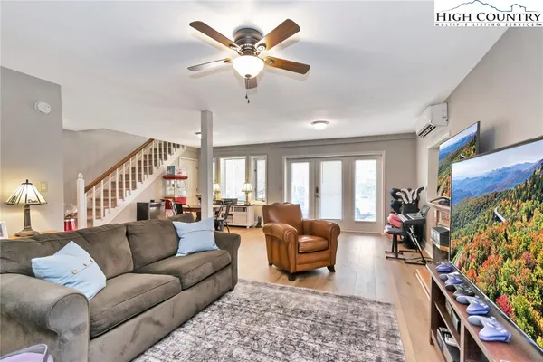 a living room with furniture fireplace and a large window