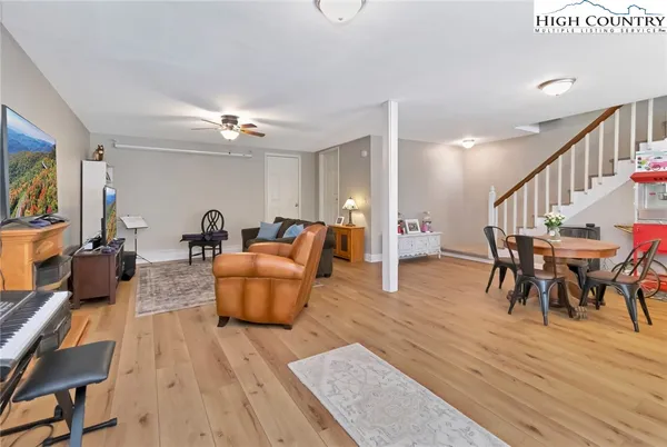 a living room with furniture and a wooden floor